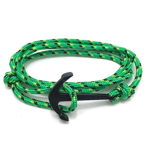 Detailed shot of green nautical paracord bracelet with a black metal anchor clasp