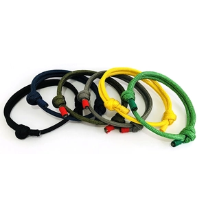 Flat lay of colorful adjustable paracord bracelets in various shades with knot details