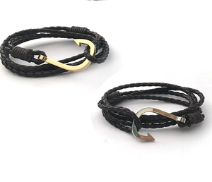 Detail of handcrafted multilayer leather bracelets with gold and silver anchor hook clasps