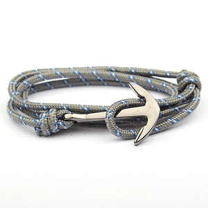Detail of nautical 3mm nylon cord bracelet in grey with blue accents and gunmetal anchor