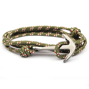 Macro view of a navy blue 3mm nylon nautical rope bracelet with a silver anchor clasp