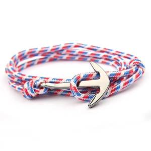Detail of red white and blue nautical braided rope bracelet with silver anchor clasp