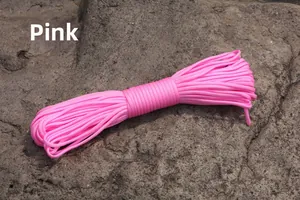 Detailed texture of pink 4mm 7-strand paracord on a natural grey rock surface