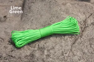 Fruit green military paracord rope for camping and outdoor tents on a natural rock background