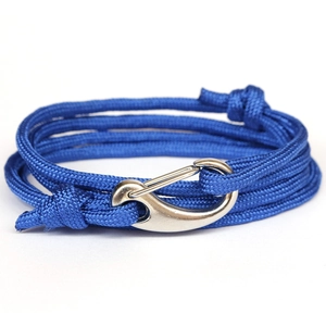 Detail of multi-layer blue braided cord bracelet with polished silver anchor hook clasp