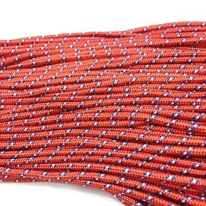 Macro shot of orange 3mm paracord with blue and white woven spots for DIY jewelry