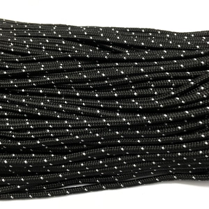 Close-up of 3mm black braided paracord with reflective white dots and dense texture