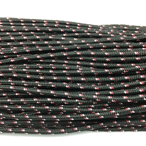 Detail of 3mm black paracord with red and white spiral woven pattern and nylon texture