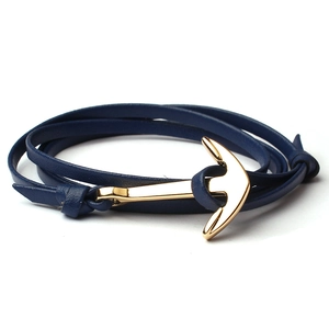 Close-up of navy blue multi-layer leather cord bracelet with golden anchor clasp