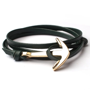 Close-up of dark green leather wrap bracelet with a polished golden anchor clasp