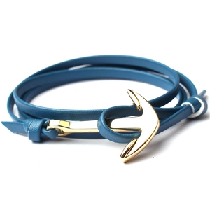 Close-up of nautical double-layer blue leather bracelet with gold anchor clasp