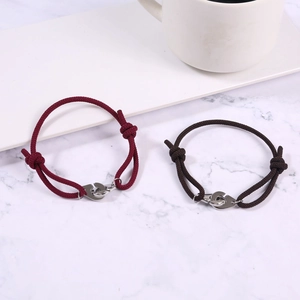 Detail of adjustable handcuff braided rope bracelets in burgundy and brown colors