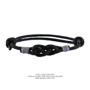 Detail of pure hand knitting heart knot bracelet made with high quality milan line