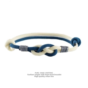 Macro shot of hand-woven Milan rope bracelet with a heart knot and adjustable cord