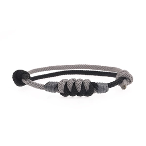 Minimalist black and grey woven concentric knot bracelet with adjustable cord closure