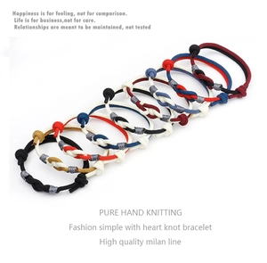 Detail showing handwoven Milan cord bracelets with heart-shaped knots in multiple colors