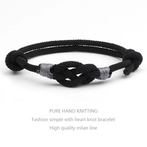 Close-up of handmade black woven concentric knot bracelet with detailed rope texture