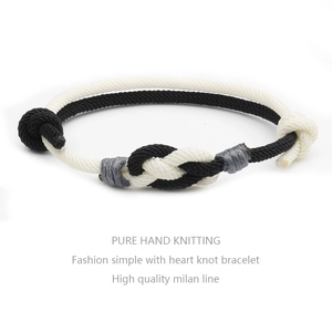 Close-up of handmade dual-tone woven heart knot bracelet with high quality milan line