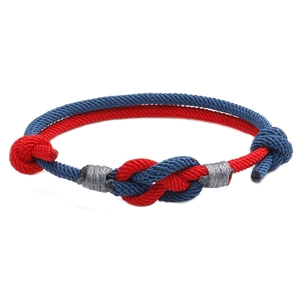 Handmade woven couple bracelet with red and blue cord knots in traditional Chinese style