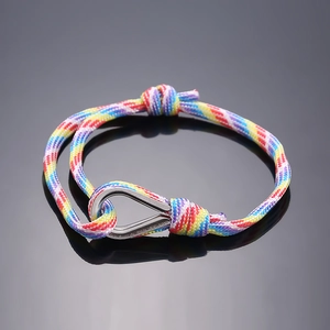 Detail of colorful braided rope bracelet with polished metal hook clasp and adjustable knot