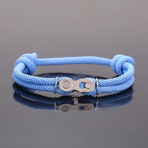 Détail du bracelet tressé bleu ciel avec un fermoir mécanique unique en forme de chaîne