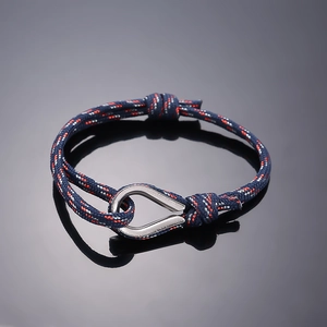 Detail of nautical paracord bracelet with navy weave and silver stainless steel shackle
