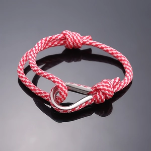 Close-up of red and white braided nautical rope bracelet with silver stainless steel U-shackle