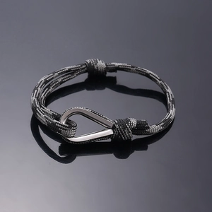 Macro detail of high-strength paracord bracelet with metallic waterdrop ring closure