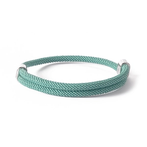 Detail of double-layered woven rope bracelet in teal with polished metal end caps
