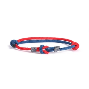 Bracciale per coppia con nodo concentrico in corda intrecciata rossa e blu e fibbia grigia