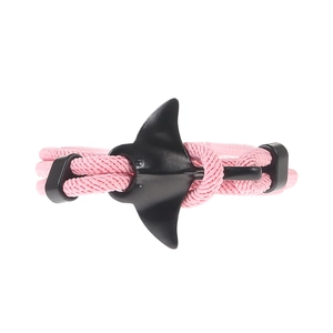 Close-up of pink woven ocean series bracelet with black manta ray shaped metal clasp