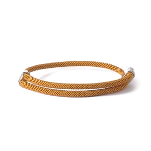Macro detail of ginger yellow double-layered braided bracelet with silver metal buckles