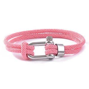 Detailed close-up of a pink woven rope bracelet with a silver stainless steel shackle clasp