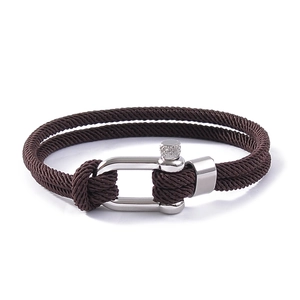 Close-up of brown braided rope bracelet with silver stainless steel U-shaped shackle