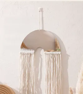Detail of bohemian handmade cotton rope macrame wall hanging mirror with fringe