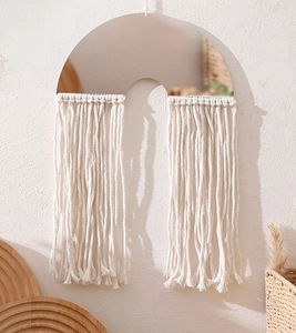 Macro detail of Bohemian cotton fringe and mirror wall hanging for home decor