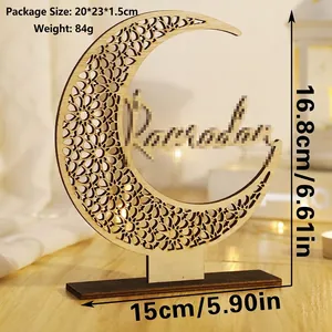 Detailed view of hollow wooden Ramadan moon ornament with artistic lettering on a dark base