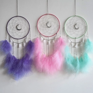 Detailed view of handmade moon dreamcatchers in purple, pink and mint green colors