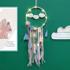 Close-up of cloud-shaped dreamcatcher with LED lights and macaron feathers