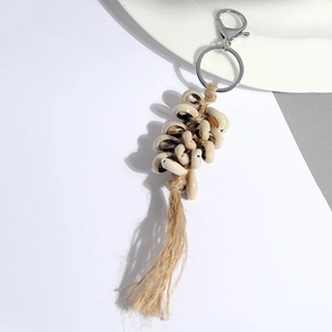Detailaufnahme vom handgefertigten Muschel-Quasten-Schlüsselanhänger mit Jute und Metallverschluss