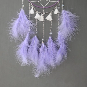Macro view of light purple lavender feathers and white tassel on Moon Dreamcatcher