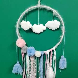 Detail showing white plush dreamcatcher ring with clouds, colorful pompons and lace ribbons