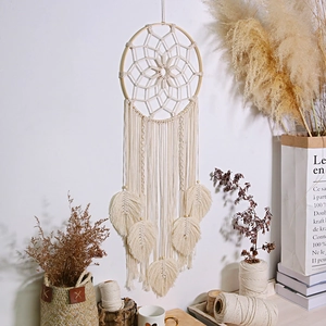 Detailed macro view of Bohemian handwoven macramé wall hanging with leaf fringe pattern