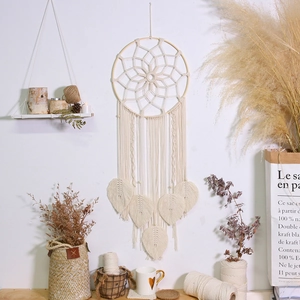Close-up of bohemian woven dream catcher featuring handmade star pattern and macrame leaves