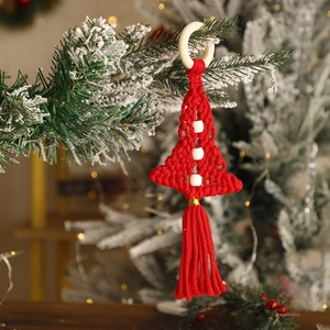 Detail of red handmade macrame Christmas tree wall hanging with wooden beads and tassels