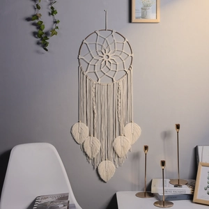 Macro detail of Bohemian woven wall hanging with cotton leaves and intricate geometric patterns