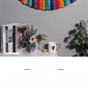 Detail of bohemian macrame rainbow wall hanging with soft cotton tassels and colorful cords
