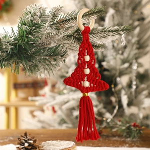 Detail of red macrame Christmas tree ornament with wooden beads and hanging ring