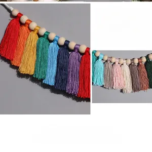 Detail of colorful handwoven macrame wall hanging with wooden beads and rainbow tassels