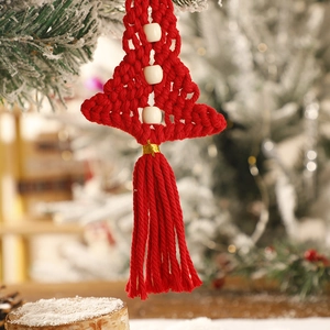Detailed close-up of a red macrame Christmas tree ornament with white beads and tassels
